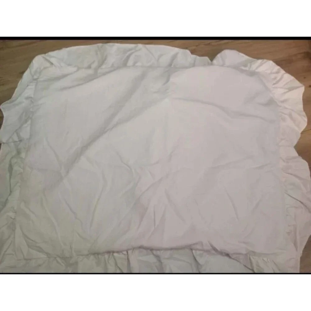 Light pink twin duvet cover with pillow sham. Ruffled edges and button close